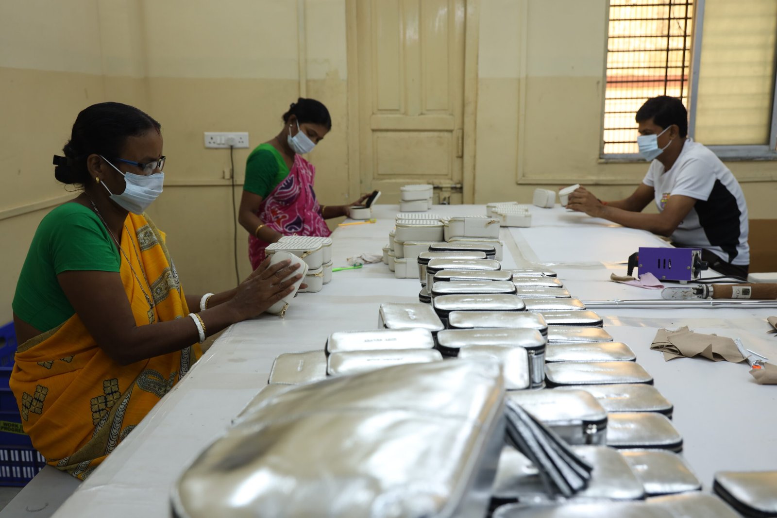 Ahmed Tannery artisans finishing leather goods by hand