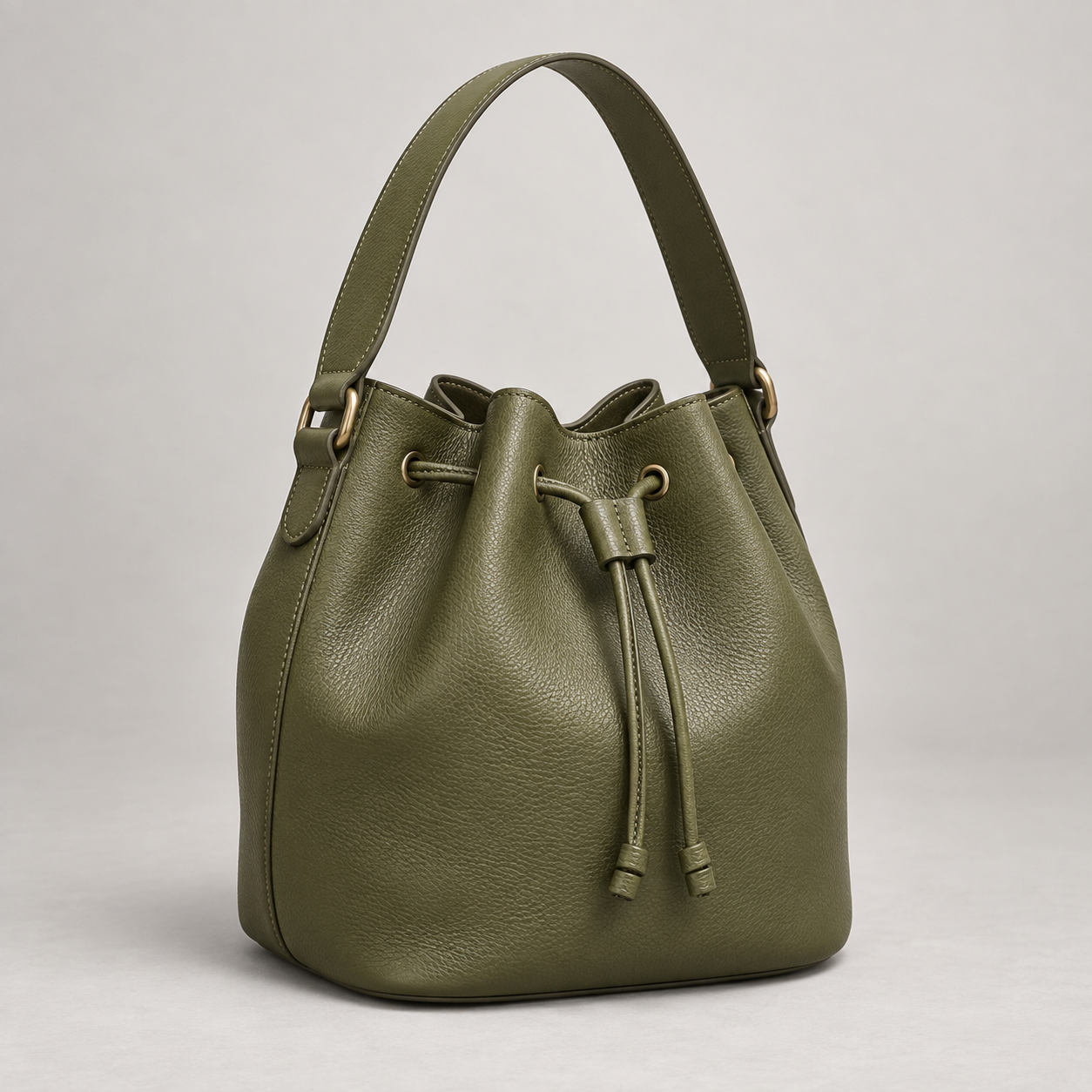 Olive Bucket: Rounded bucket bag with a drawstring top and a single broad shoulder strap. Illustrative design reference.